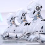 Four Robots working with laptop