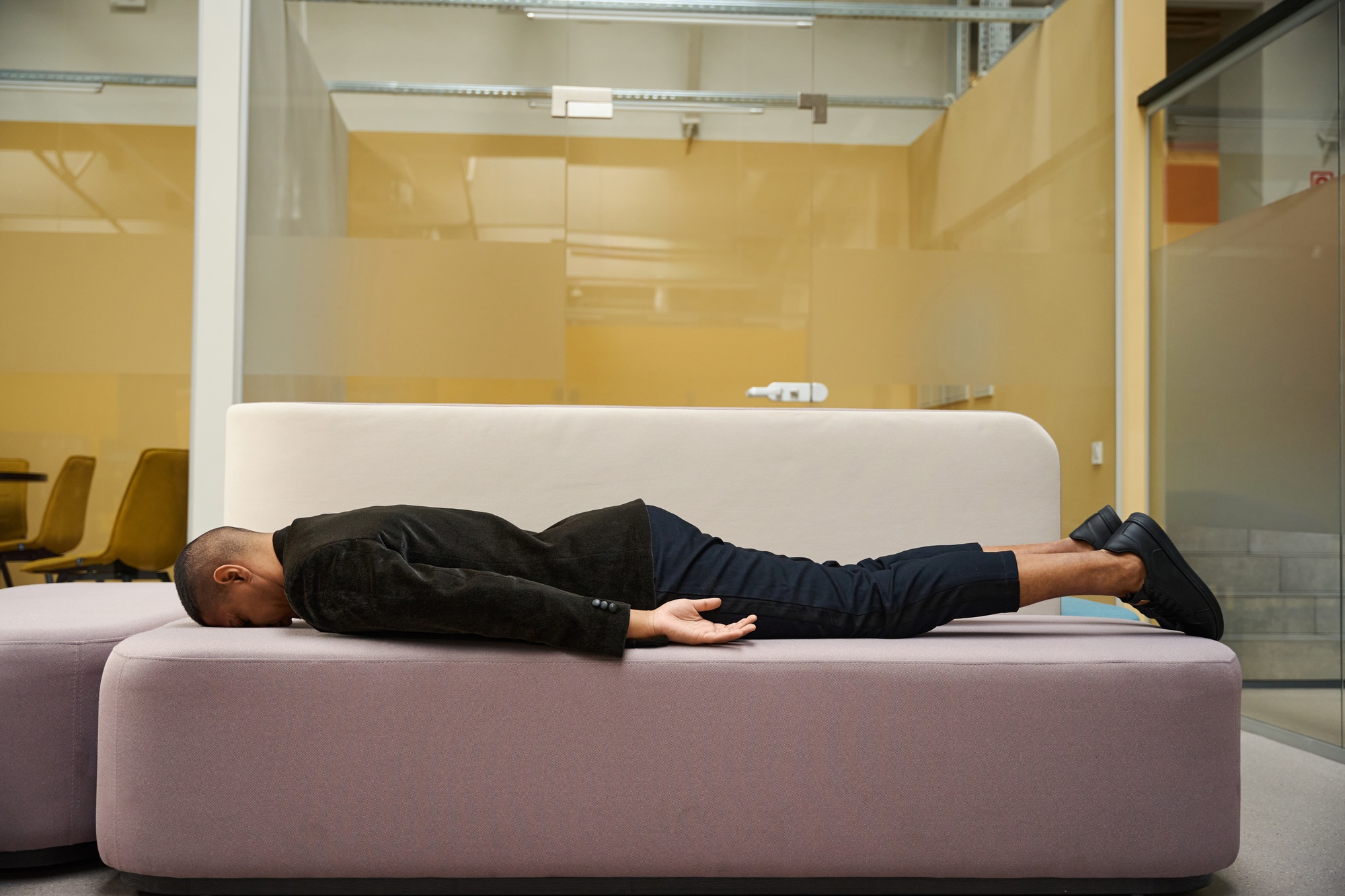 Burnout at work. Tired male employee sleeping on sofa in office